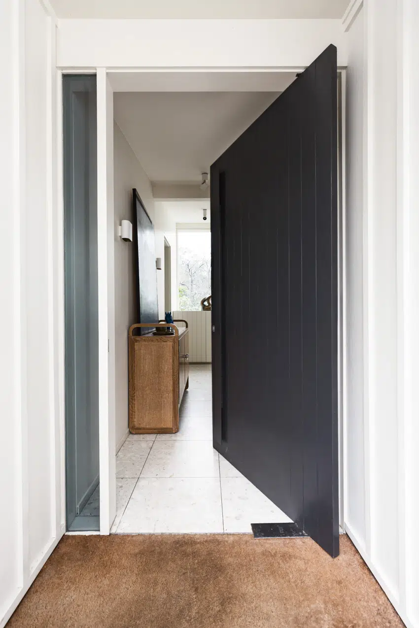 Black pivot door at front of house