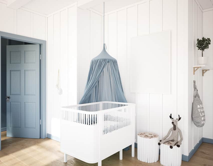 Blue door, baby crib and white walls