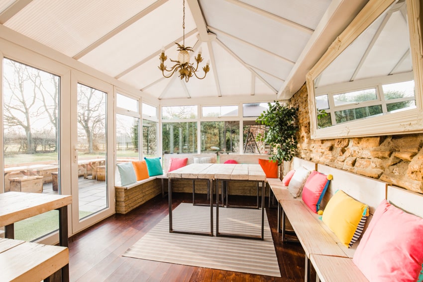 Chandelier light hanging outdoor area with roof and furniture