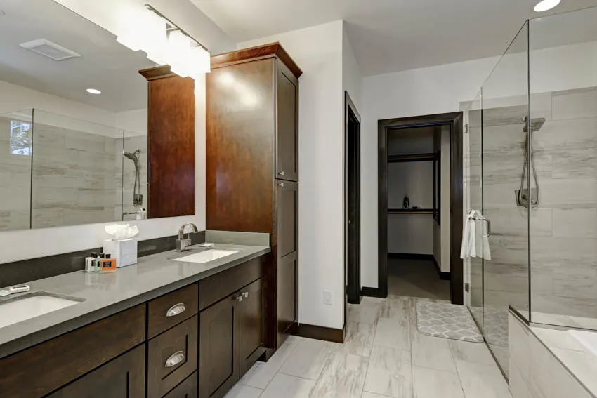 Classic bathroom with countertop mirror wood cabinet drawers shower area