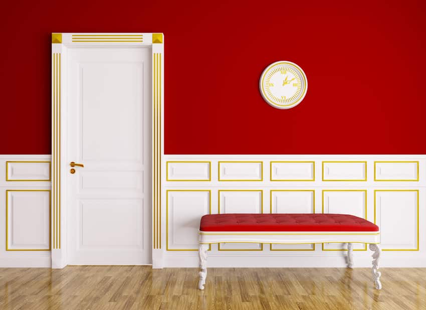 Classic red and gold interior with couch and door