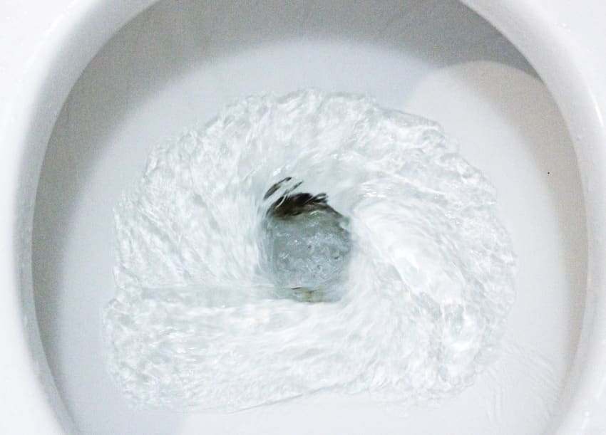 Close up of flushing toilet bowl