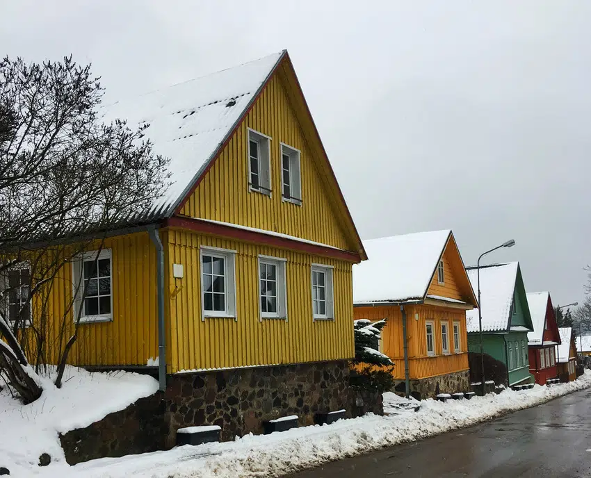 Colorful houses in winter with board and batten siding