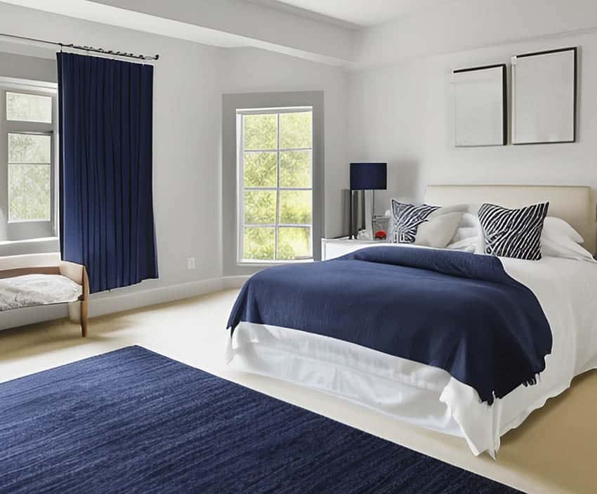 Contemporary bedroom with navy blue rug curtains and bed spread