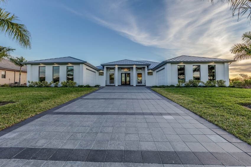 Contemporary house with front lawn and concrete paver driveway