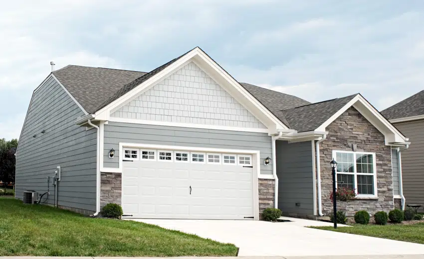 Contemporary house with white garage door and fiber cement siding