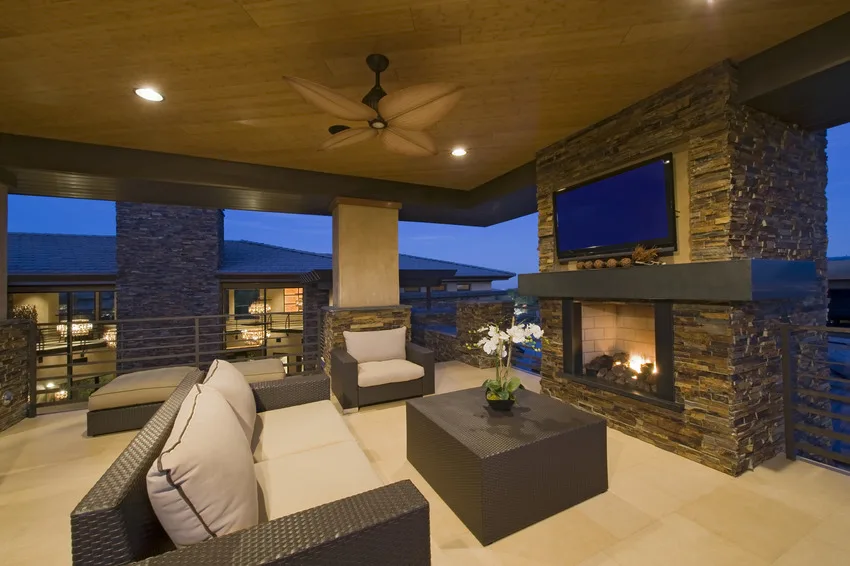 Covered patio with comfy furniture and fireplace
