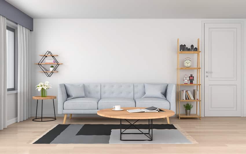 Cozy living room with gray sofa wooden table and stylish rug