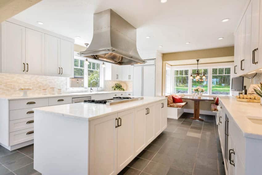 Dining nook in kitchen with center island hood cabinets drawers