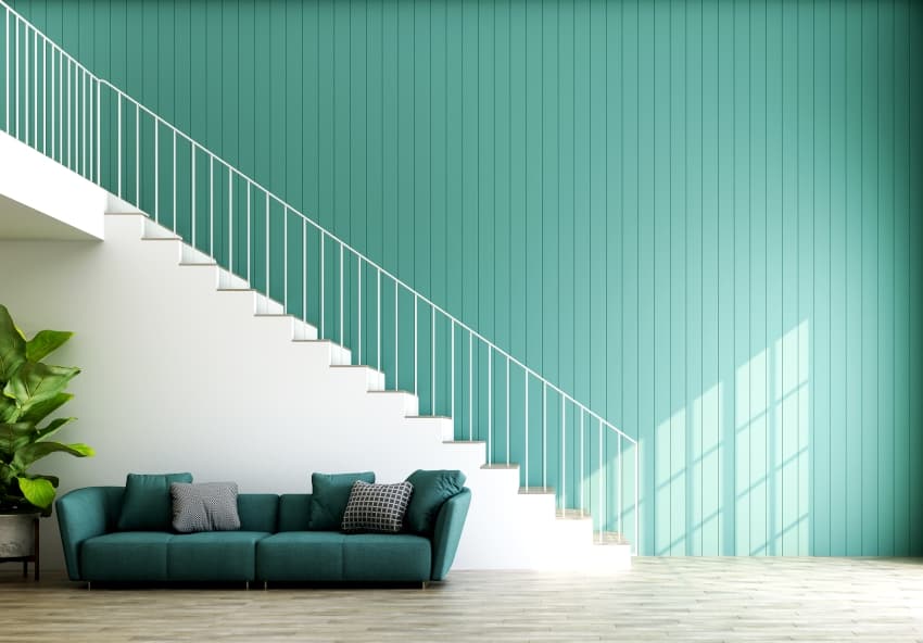double space modern loft interior with teal paint walls and a staircase