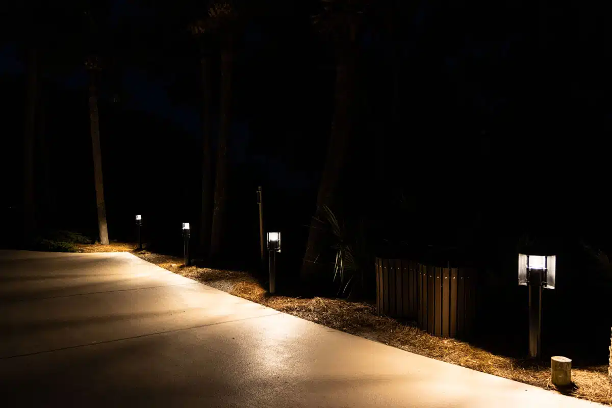 driveway lit by lighting fixtures at night