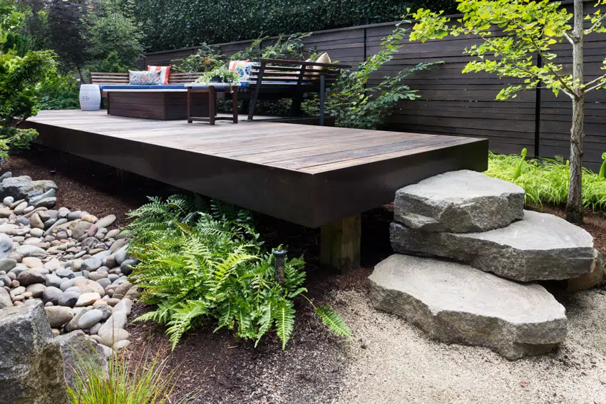 Elevated wood deck with landscaped rock features