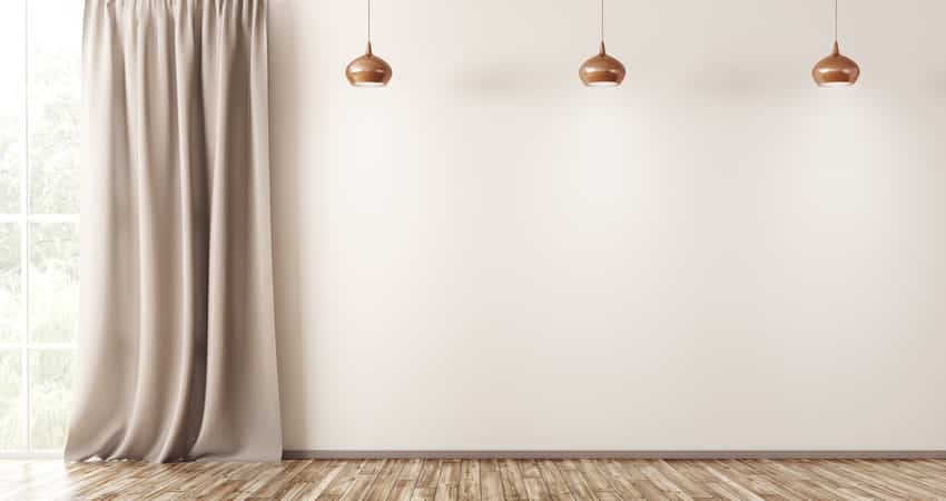 Empty room with beige walls neutral curtain and gold fixtures