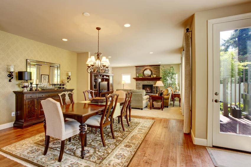 Formal living room and dining area wood floor center rug chandelier