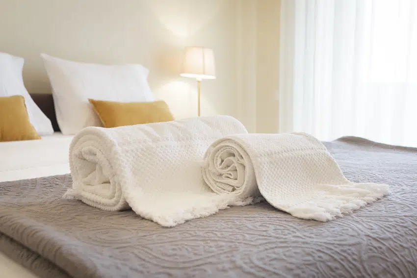Fresh and clean towels on hotel bed