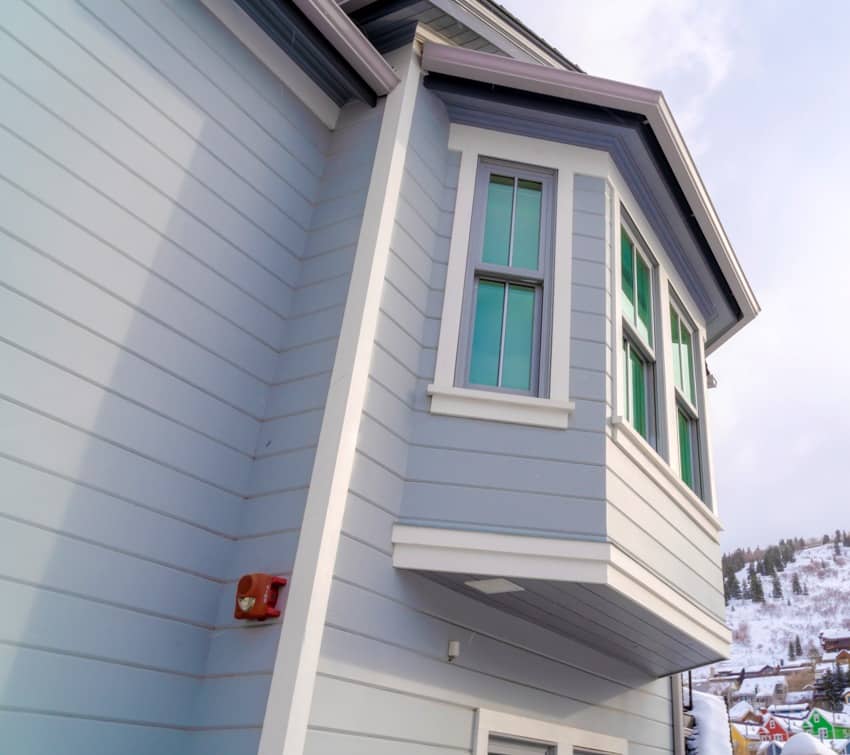 House with bay window and gray horizontal hardie siding