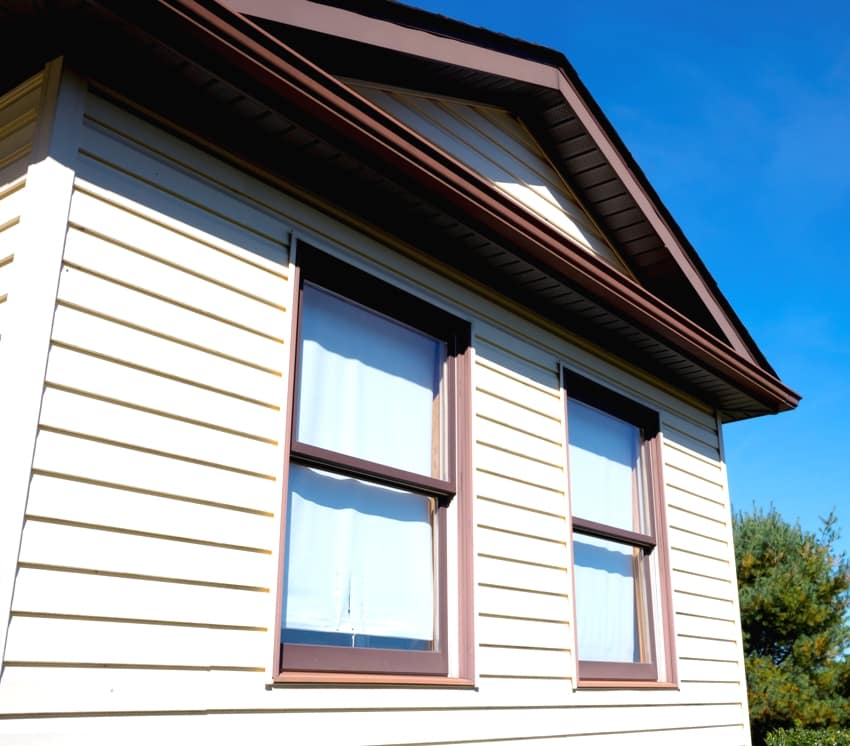 House with pale yellow vinyl siding