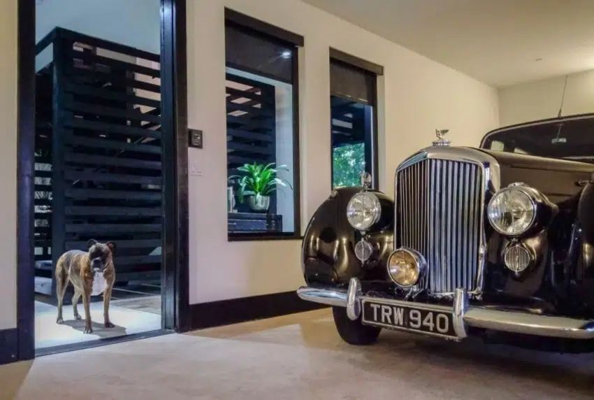 Interior car garage with old fashioned sleek black car 