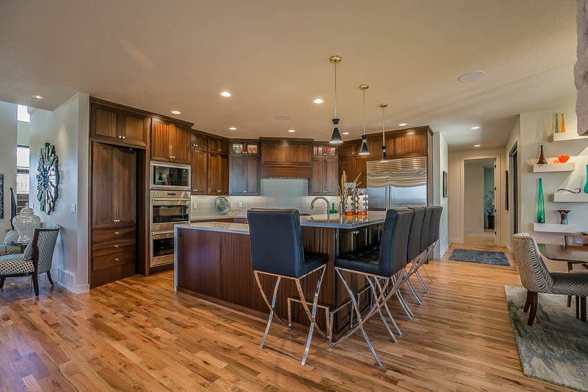 Kitchen and dining area with center island stools and wooden floor