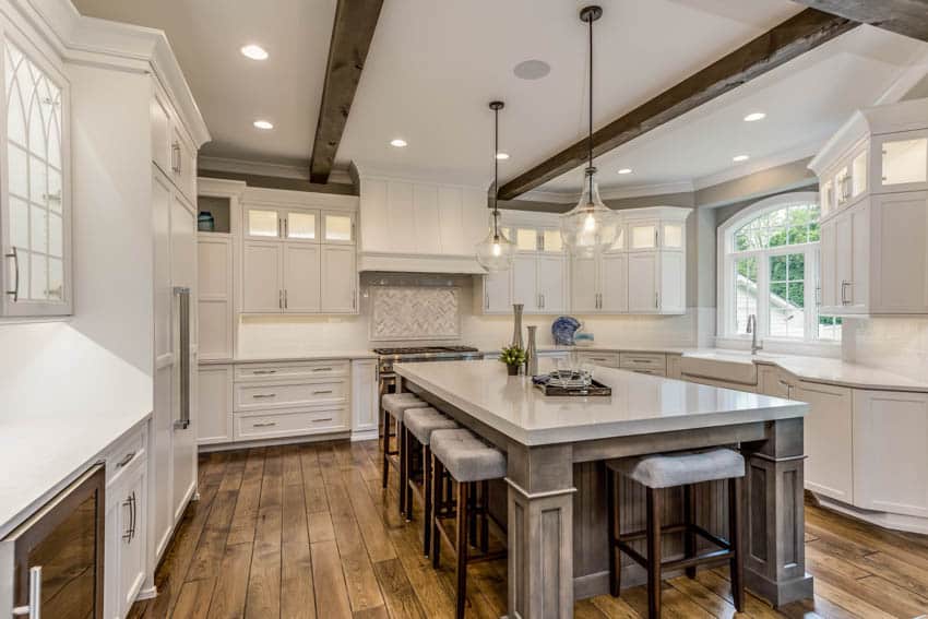 Kitchen and dining space with center island pendant lights and wooden flooring