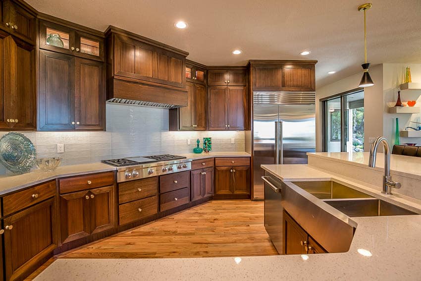 Kitchen area with wooden cabinets floors drawers stove sink