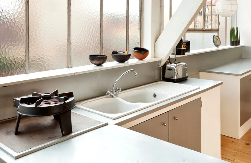 Kitchen cast iron sink with burner and toaster on both sides