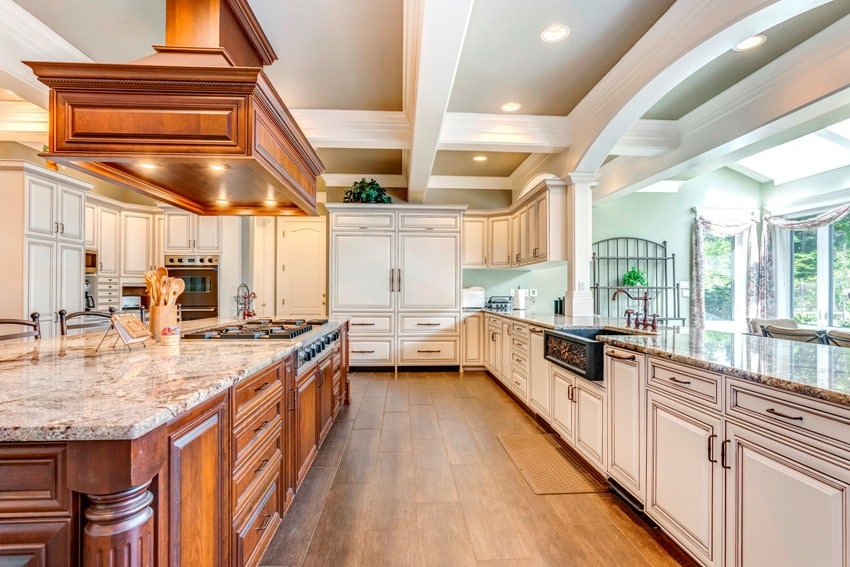 kitchen interior with large bar style island and gray coffered ceiling
