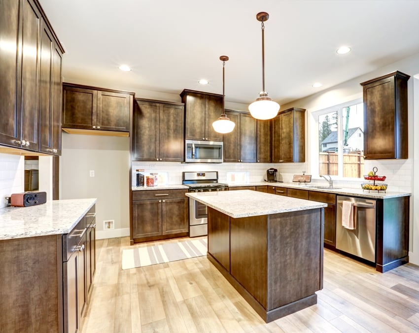kitchen interior with wood flooring granite countertop and white cabinets