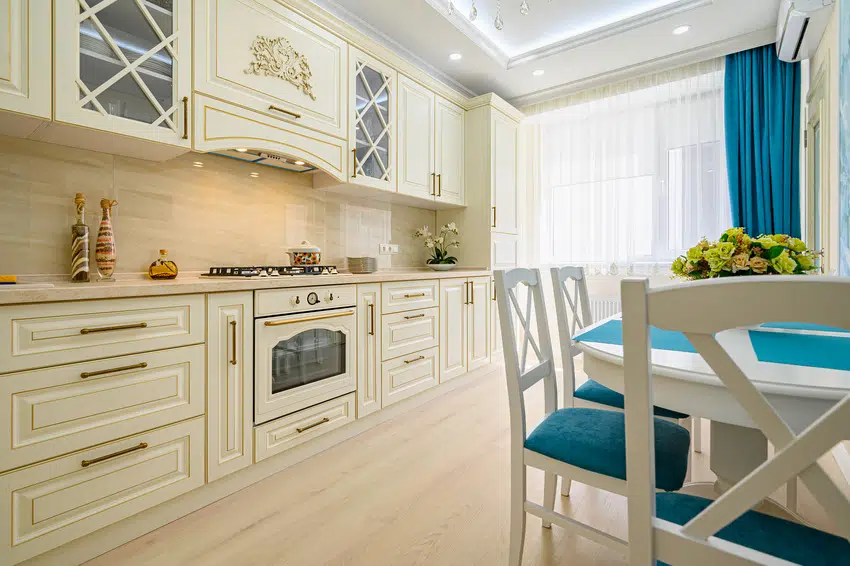 Kitchen with beige white and cyan furniture and accents
