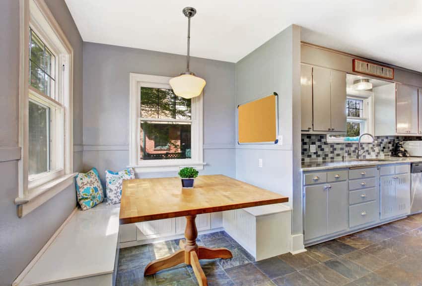 Kitchen with booth area hanging light tiled floor