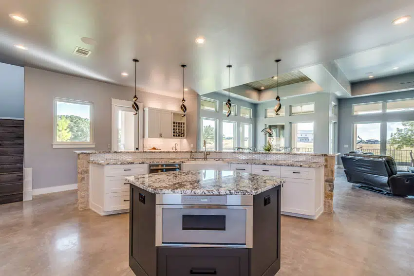Kitchen with two tier island breakfast bar and island with oven