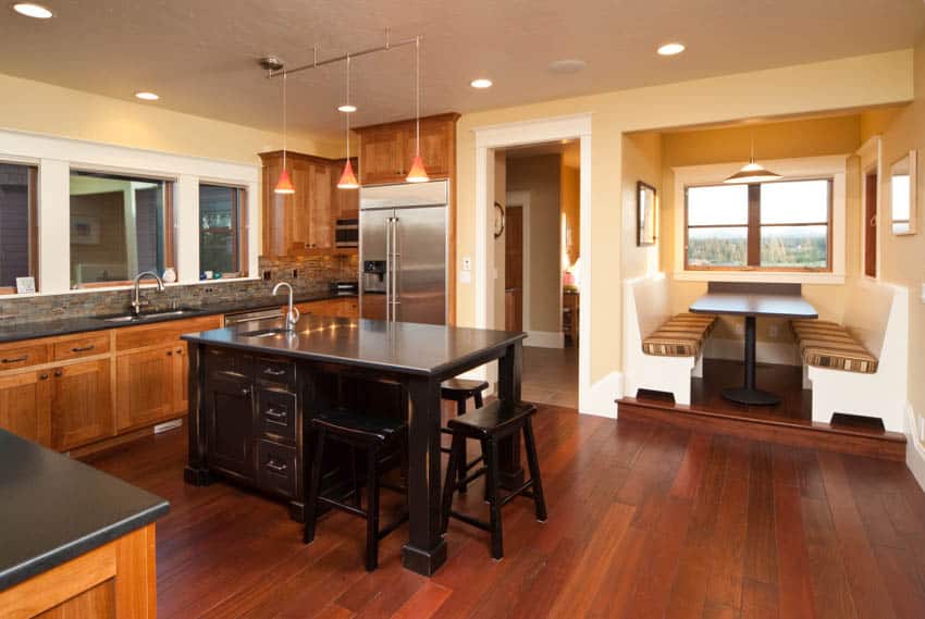 Kitchen with wood flooring cabinet island and booth