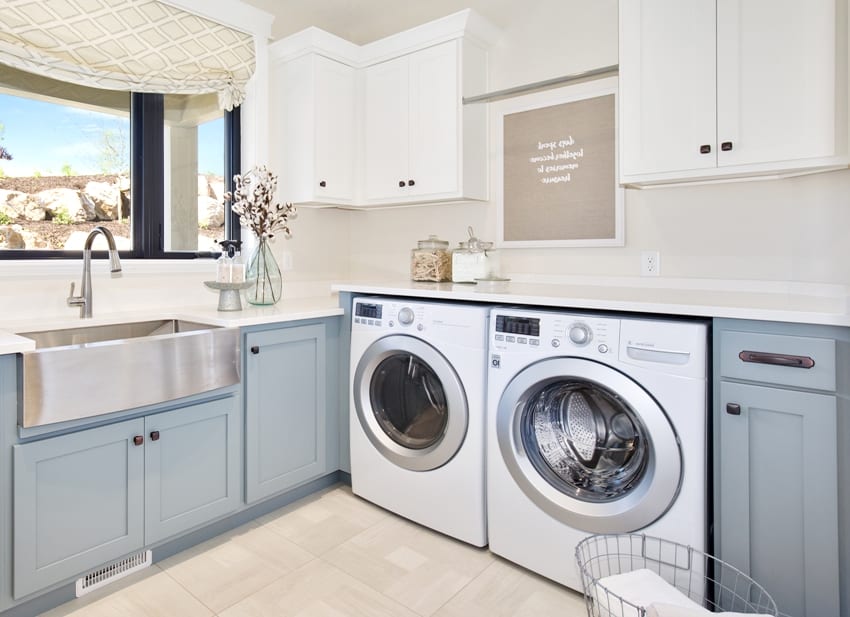 large laundry room with basin sink and front loading washing machine countertop and dryer