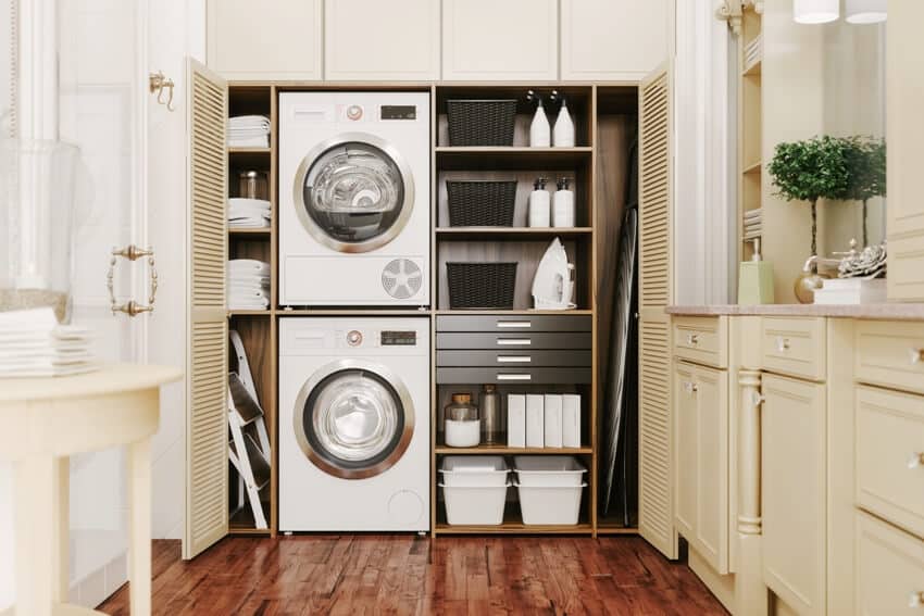 Laundry area in bathroom with wooden floors and laundry supplies inside the cabinet