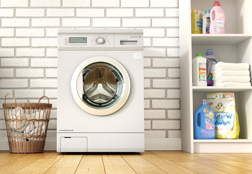 laundry room on a brick wall background with wooden floors detergents on the side and a basket