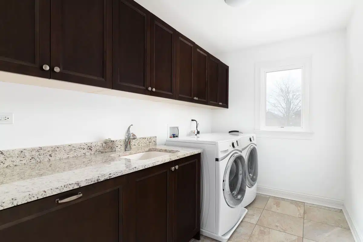 laundry with built-in cabinets windows and countertop