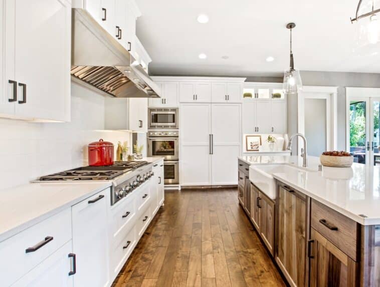 Cabinet Refacing Vs Painting   Light Filled Northwest Kitchen Design With Kitchen Island Natural Brown Cabinets Topped With Granite Countertops And Paired With White Backsplash Is 758x573 