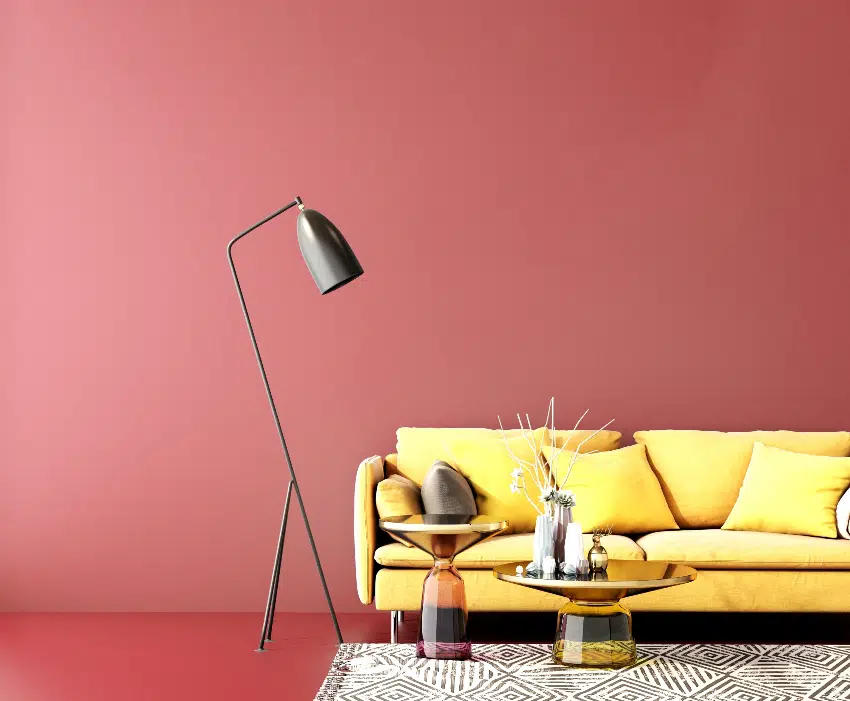 living area with burgundy wall yellow sofa floor lamp cute center table with accent decors on top