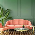 Living room interior with coral sofa and chair plus classic green walls