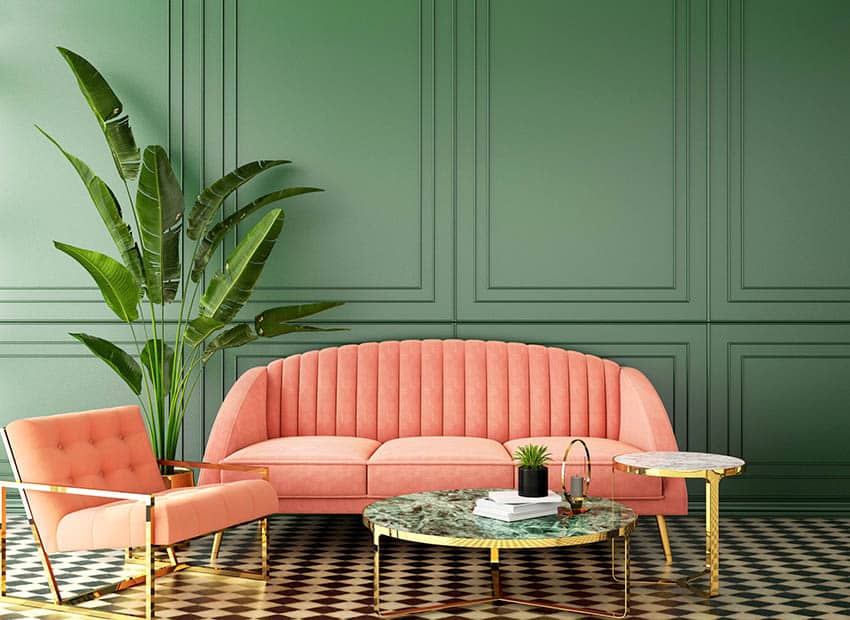 Living room interior with coral sofa and chair plus classic green walls