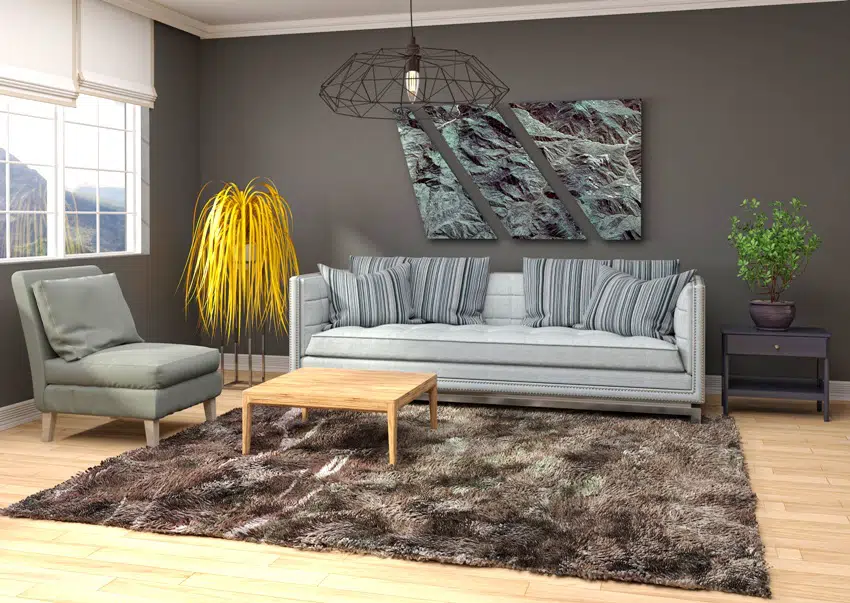 living room interior with gray in dark shade, brown capet on wooden floor and furniture
