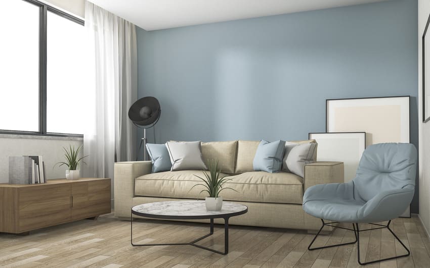 Living room interior with light blue walls couch accent pillows and wooden console table