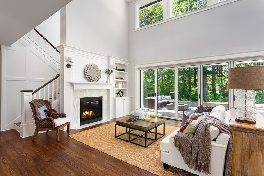 living area decked in bamboo rug and glass-front fireplace