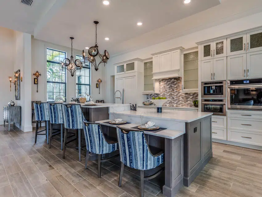 Luxury kitchen with center island wood floors and chairs