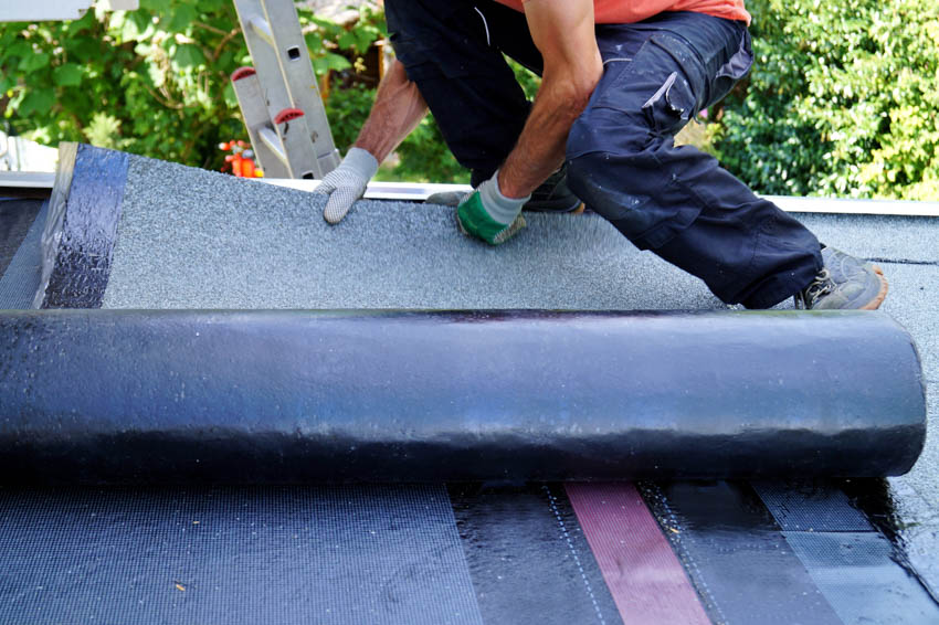 Man attaching self adhesive membrane