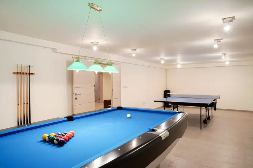 Man cave with billiards table and hanging lights
