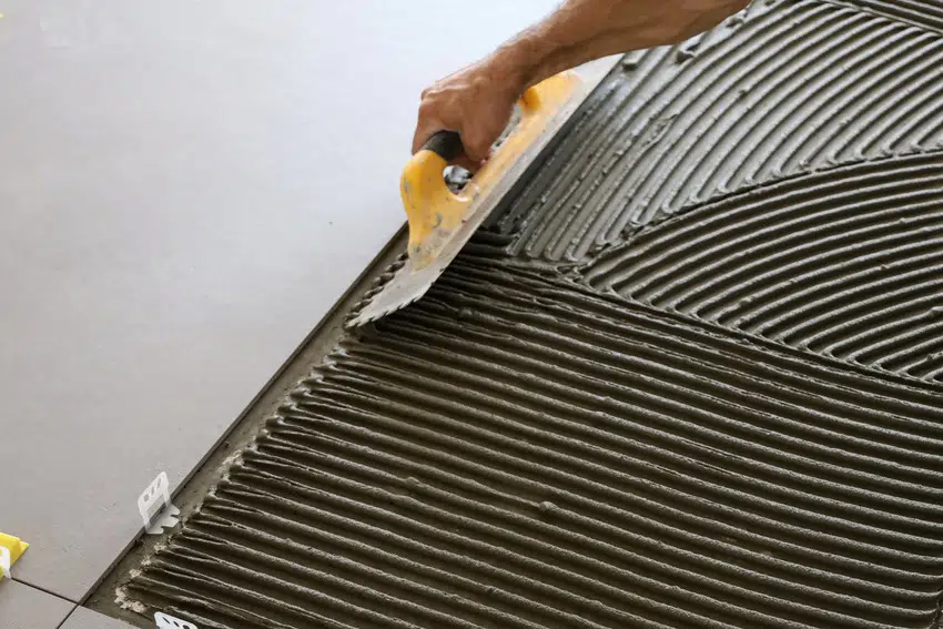 Man resurfacing garage floor