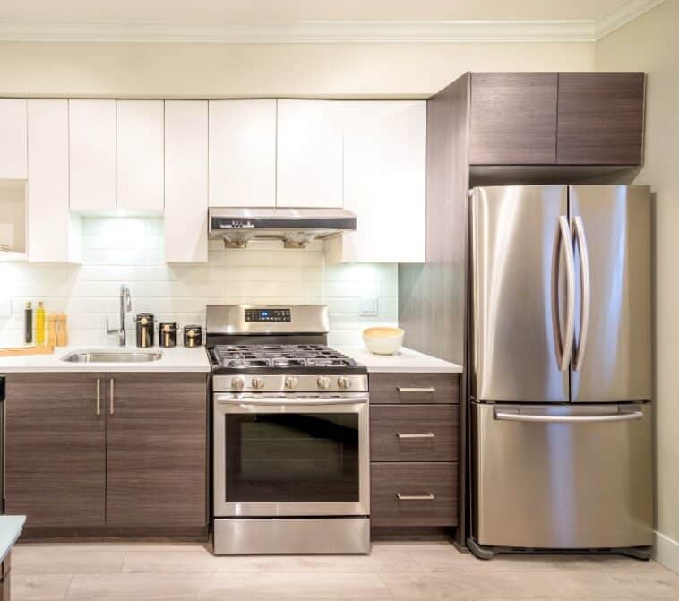 Modern Bright Kitchen Interior With A Dinner Table Refrigerator Gas Range And White Overhead Cabinets Is 758x671 