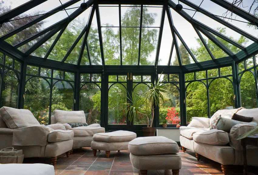 Modern conservatory with cozy furniture and refreshing nature view