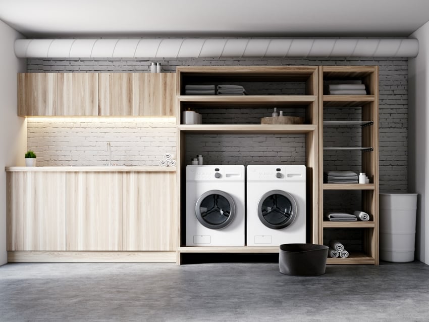 modern garage laundry room interior with white brick walls wooden consoles and shelves with two white washing machines